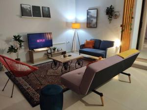 a living room with a couch and a tv at Litohome Litochoro The Gods Oasis in Litochoro