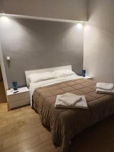 a bedroom with a bed with two towels on it at Ak Holidays Apartment 59 in Bologna