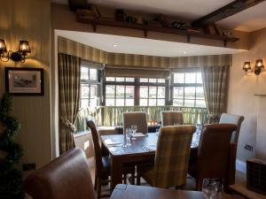 a dining room with a table and chairs and a window at The Blue Bell at Arkendale in Knaresborough