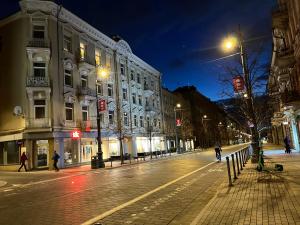 a city street at night with people walking on the street at Forentinn Gedimino pr. in Vilnius