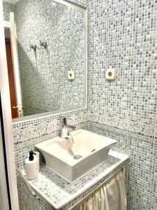 La salle de bains est pourvue d'un lavabo et d'un miroir. dans l'établissement CUATRO CAMINOS, à Madrid