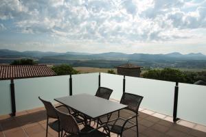 a table and chairs on a balcony with a view at El torreon de la Bruna in Artieda