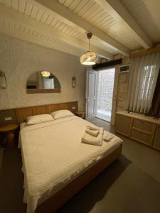 a bedroom with a large bed and a window at Monk Hotel Alaçatı in Alacati