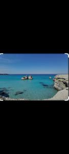 vistas a una playa con rocas en el agua en La Curte, en Melendugno