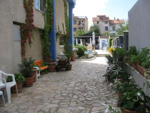 a stone walkway with potted plants on the side of a building at Villa Sens in Chernomorets