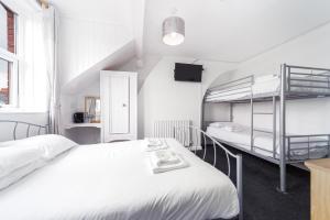 a bedroom with two beds and a bunk bed at Blencathra in Whitby