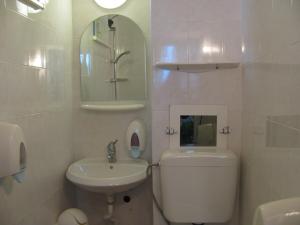 a bathroom with a sink and a toilet and a mirror at Villa Sens in Chernomorets +15 photos