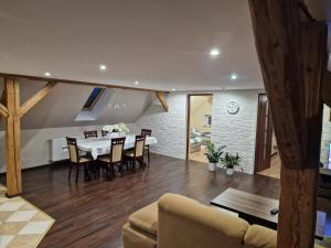 a dining room and living room with a table and chairs at Asieńka 1 in Mirsk +10 photos