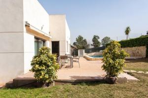 un patio con mesa y sillas junto a un edificio en Villa Morga Privada,Lujo, Relax,calicanto valencia en Valencia