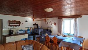 a kitchen and dining room with a table and chairs at Rodinná chalupa in Zdíkov