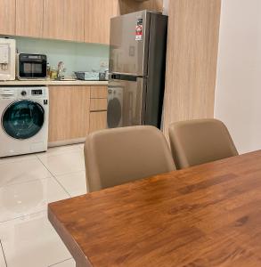 a kitchen with a table and chairs and a refrigerator at [Starry Homes x Classic] 2Beds+2Bath *Free Netflix in Masai