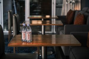 two bottles of soda sitting on a table at SIRTAJ – Beverly Hills in Los Angeles