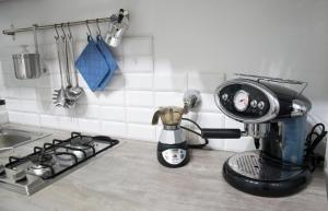 a kitchen counter with a coffee maker and a mixer at bocca di lupo in Genova