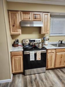 a small kitchen with a stove and a sink at s2. Lakeside house in Scottsboro in Scottsboro