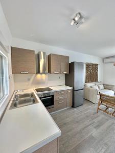 a kitchen with a sink and a stove top oven at Athos Blue Nikiti 1 in Nikiti