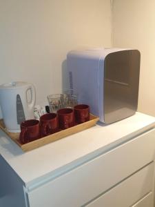 a tray of coffee cups and a microwave on a counter at The Chorlton in Blackpool