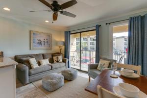 a living room with a couch and a table at Bright Beach Condo on 50-Acre Hilton Head Resort! in Hilton Head Island