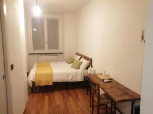 um quarto com uma cama, uma mesa e uma secretária em Affittacamere Armanino em Gênova