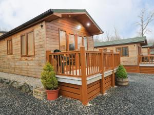 a log cabin with a large deck and a house at 8 Woodlands in Ulverston