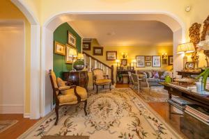una sala de estar con paredes verdes y una escalera. en Lawrence House - Deluxe - Cascais, en Cascais