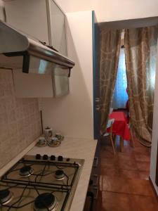 a kitchen with a stove and a counter top at Mini appartamento in Livorno