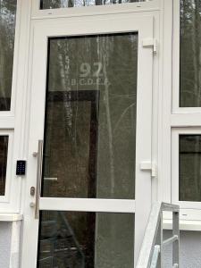 a glass door of a house with a sign on it at Apartamenty Ustroń Jaszowiec 92 abc in Ustroń