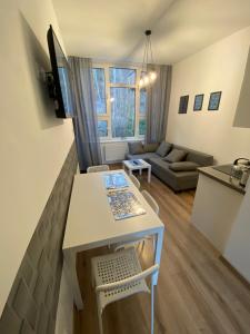 a small living room with a table and a couch at Apartamenty Ustroń Jaszowiec 92 abc in Ustroń