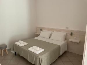 een slaapkamer met een bed met twee handdoeken erop bij Agriturismo Terra Rossa in Otranto