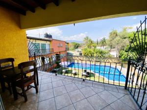 a balcony with a view of a swimming pool at Hotel Cabañas Santa Cruz in Oaxtepec