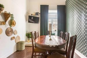 a dining room with a wooden table and chairs at Ti Maria Guest House in Faro