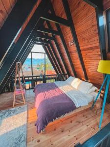a bedroom with a bed and a ladder in a attic at Wonder of nature bungalov sapanca in Sapanca