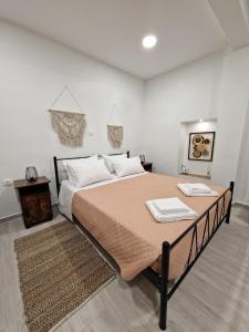 a bedroom with a large bed with two towels on it at Granny's Nest in Kalyves