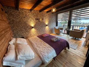 a bedroom with a bed and a brick wall at Wonder of nature bungalov sapanca in Sapanca