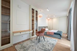 a bedroom with a bed and a desk and a chair at Unique&Luxury Penthouse With Tarrace&Parking in Łódź