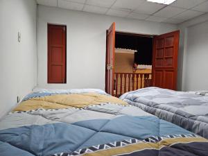 En eller flere senge i et værelse på COZZY APARTMENT IN AYACUCHO