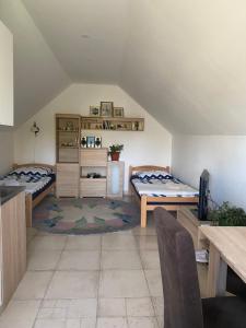 维尔蒂尼克Ilkićev kućerak Studio的阁楼房间，有两张床和一张桌子