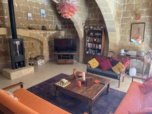 a living room with a couch and a coffee table at Dar Dragun: luxury 3BR bright spacious house & pool in San Lawrenz