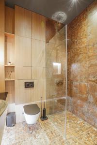 a bathroom with a shower with a tub and a toilet at Forentinn Gedimino pr. in Vilnius