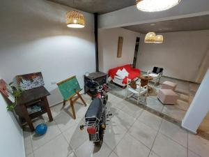 an aerial view of a living room with a motorcycle in it at Cuestas Del Búho Casa Serrana in Agua de Oro