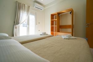Postel nebo postele na pokoji v ubytování Kyriakos Apartment