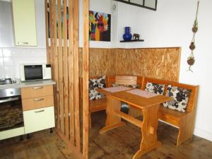 a small kitchen with a wooden table and chairs at Appartement Rez de chaussée Résidence les Oliviers in Langeac