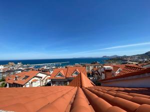 a view of the roofs of a city at Villa OLYMPIA in Castro-Urdiales