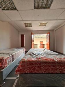 a room with two beds and a window at Cozzy apartment en pleno Centro! in Ayacucho
