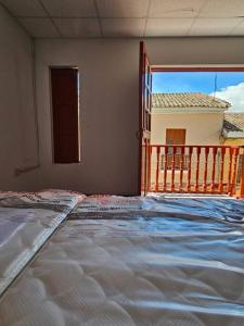 a large bed in a room with a balcony at Cozzy apartment en pleno Centro! in Ayacucho