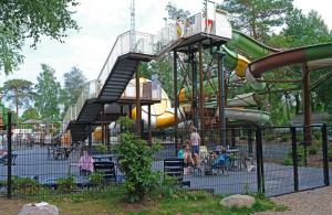 a playground with a slide in a park at Forest Feelings - op 5 sterren park met heerlijke privé tuin in Beekbergen