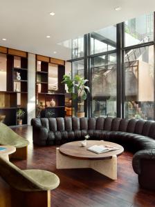 a living room with a leather couch and a coffee table at South Congress Hotel in Austin