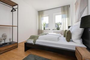 a bedroom with a large bed and a window at Center Dream Apartment - Netflix in Krefeld