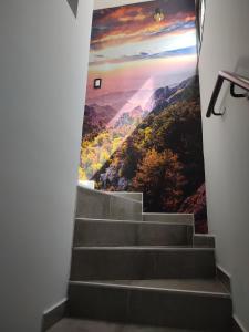 a mural on the wall of a stairway with a painting at 787 Suites in La Cieneguita