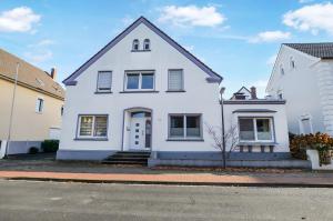a white house sitting on the side of a street at AT WEINMEISTER - Gemütlichkeit & Ruhe in Gütersloh