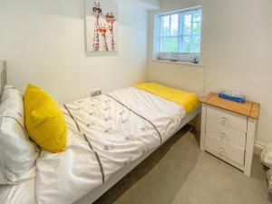a small bedroom with a bed and a window at Lilliput Cottage in Wangford